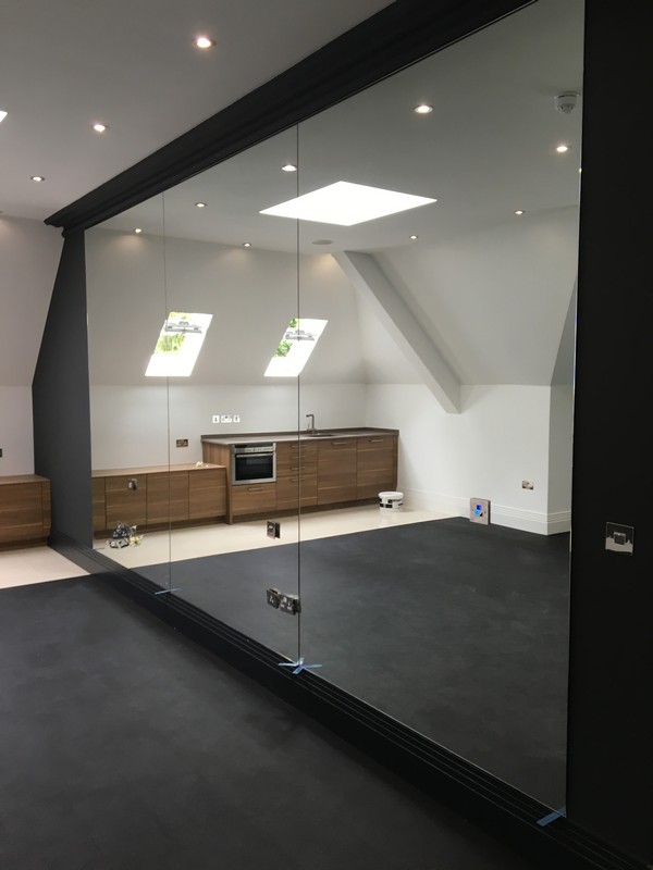 Frameless glass partition in loft conversion by Catford glaziers