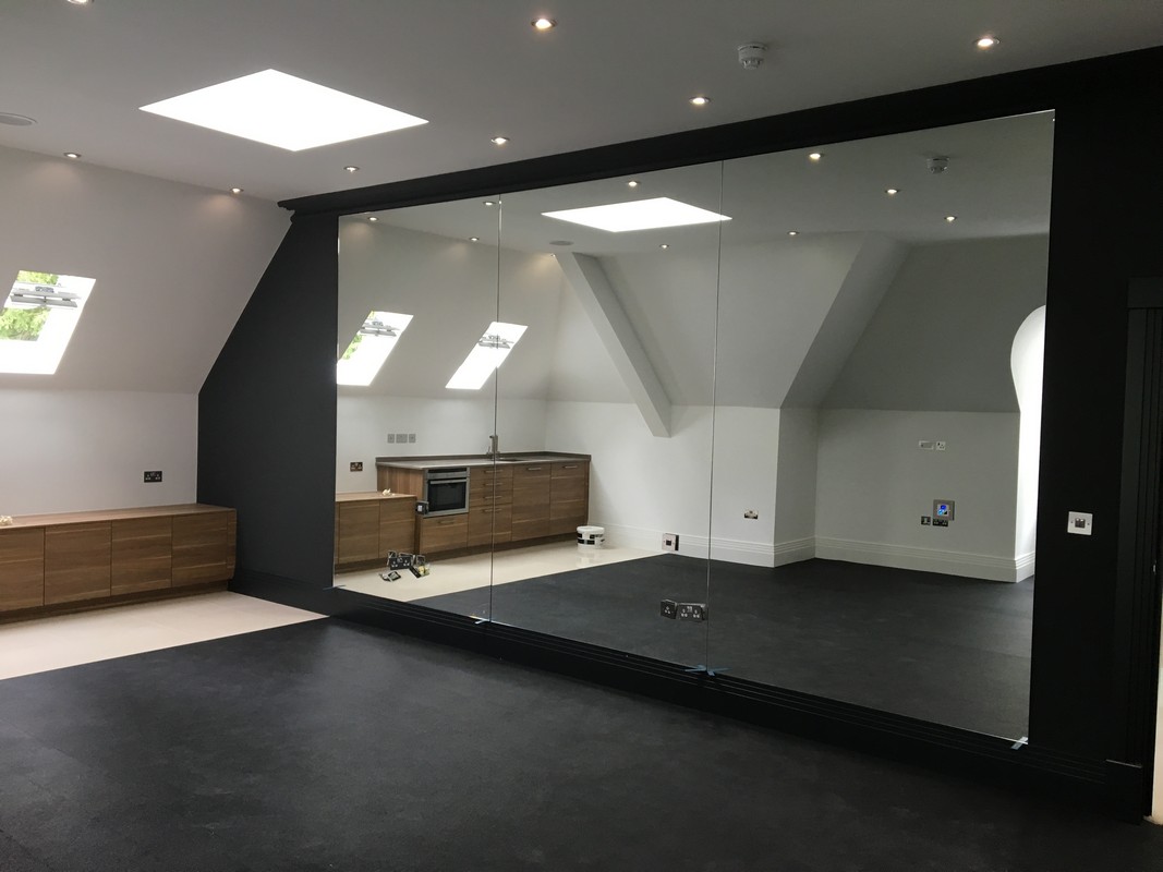 Frameless glass wall dividing loft conversion in Catford